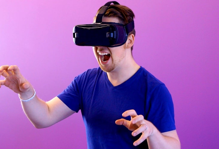 A yougn man having fun with VR headset